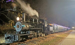 Train parked at night during fall; Photo Credit: Maine Narrow Gauge