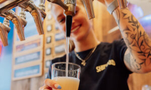 Bartender Pouring Beer on Tap; Photo Credit: Shipyard Brewing Co.