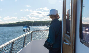 Man standing by door on boat: Photo Credit: Maine Maritime Museum