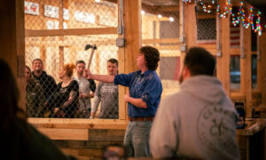 Person teaching others to throw axes; Photo Credit: Nate Davis