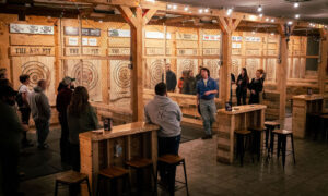 Person teaching others to throw axes; Photo Credit: Nate Davis