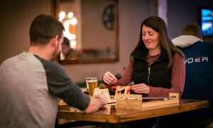 Couple drinking at The Axe Pit; Photo Credit: Nate Davis