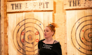 Woman walking back from getting axe; Photo Credit: Nate Davis