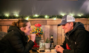 Couple drinking at The Axe Pit; Photo Credit: Nate Davis