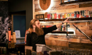 Bartender grabbing drinks; Photo Credit: Nate Davis