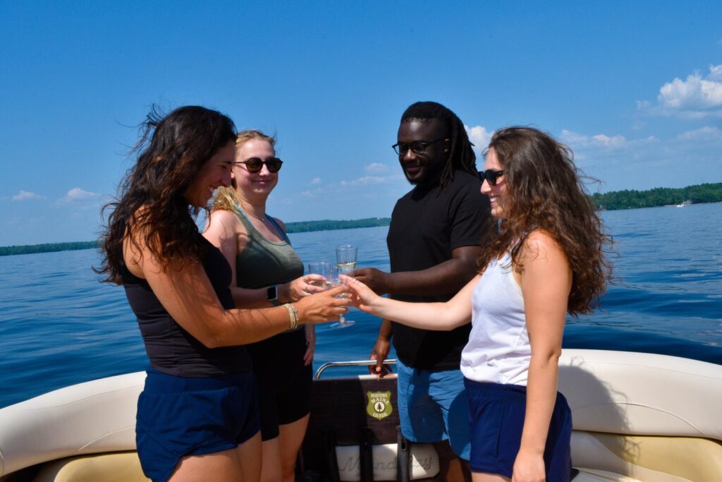 Friends Doing a Cheers on Sebago Lake Cruises. Photo Credit: Kelly Schneck