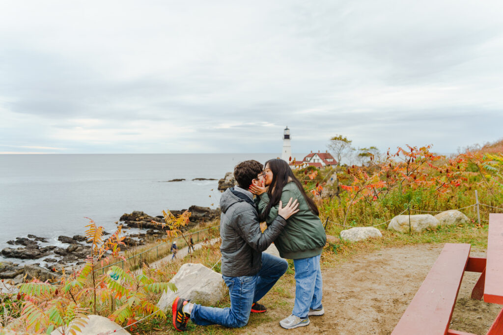 Couple Getting Engaged by Portland Head Light. Photo Credit: Sravya Khasnavees
