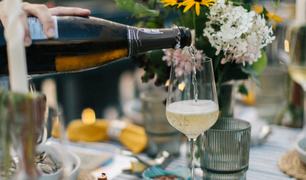 Pouring glass of wine. Photo Credit: Greta Tucker Photography
