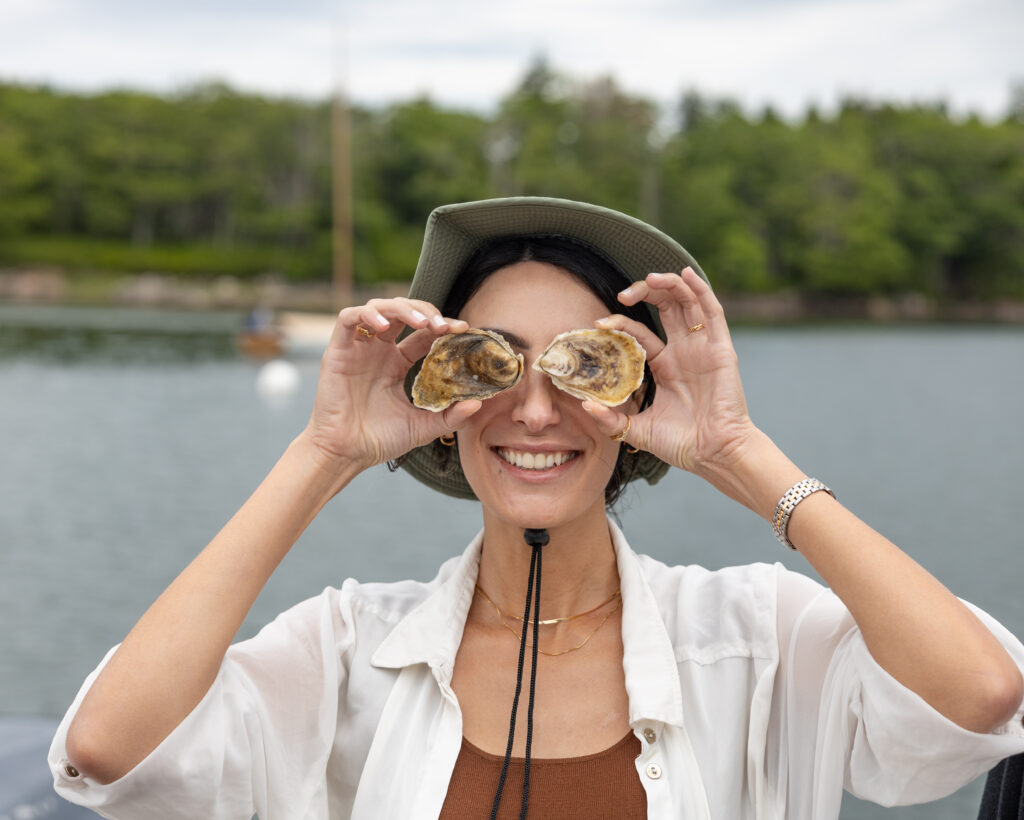 Posing with oysters. Photo Credit: Greta Tucker Photography