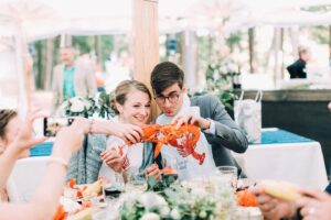 Couple eating lobster. Photo Provided by The Maine Lobsterbake Co