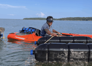Kayaking to tend to oyster farm. Photo Credit: Indigo Oyster Company