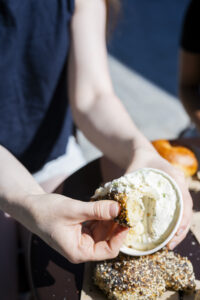 Bagel Dipped in Cream Cheese at PopUp Bagels. Photo Credit: Capshore Photography.