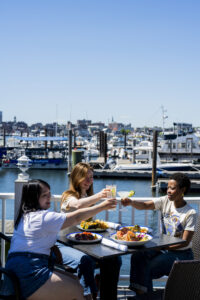 Cheers at Saltwater Grille. Photo Credit: Capshore Photography.