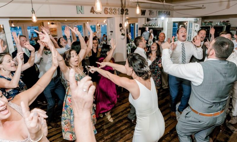 A group of people dancing and celebrating at a wedding reception in Portland Maine.