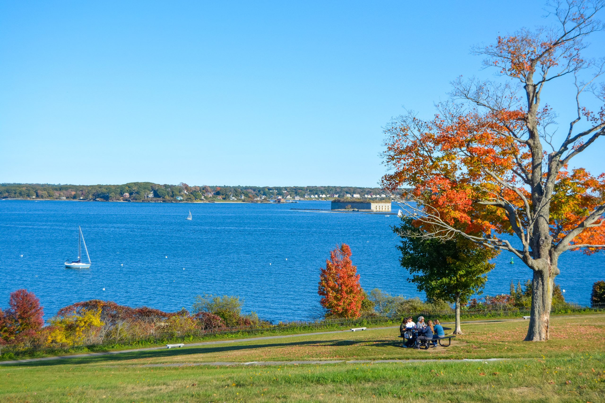 Casco Bay with sailboats and autumn trees in Portland, Maine. Photo Credit: Lauren Witt Peters