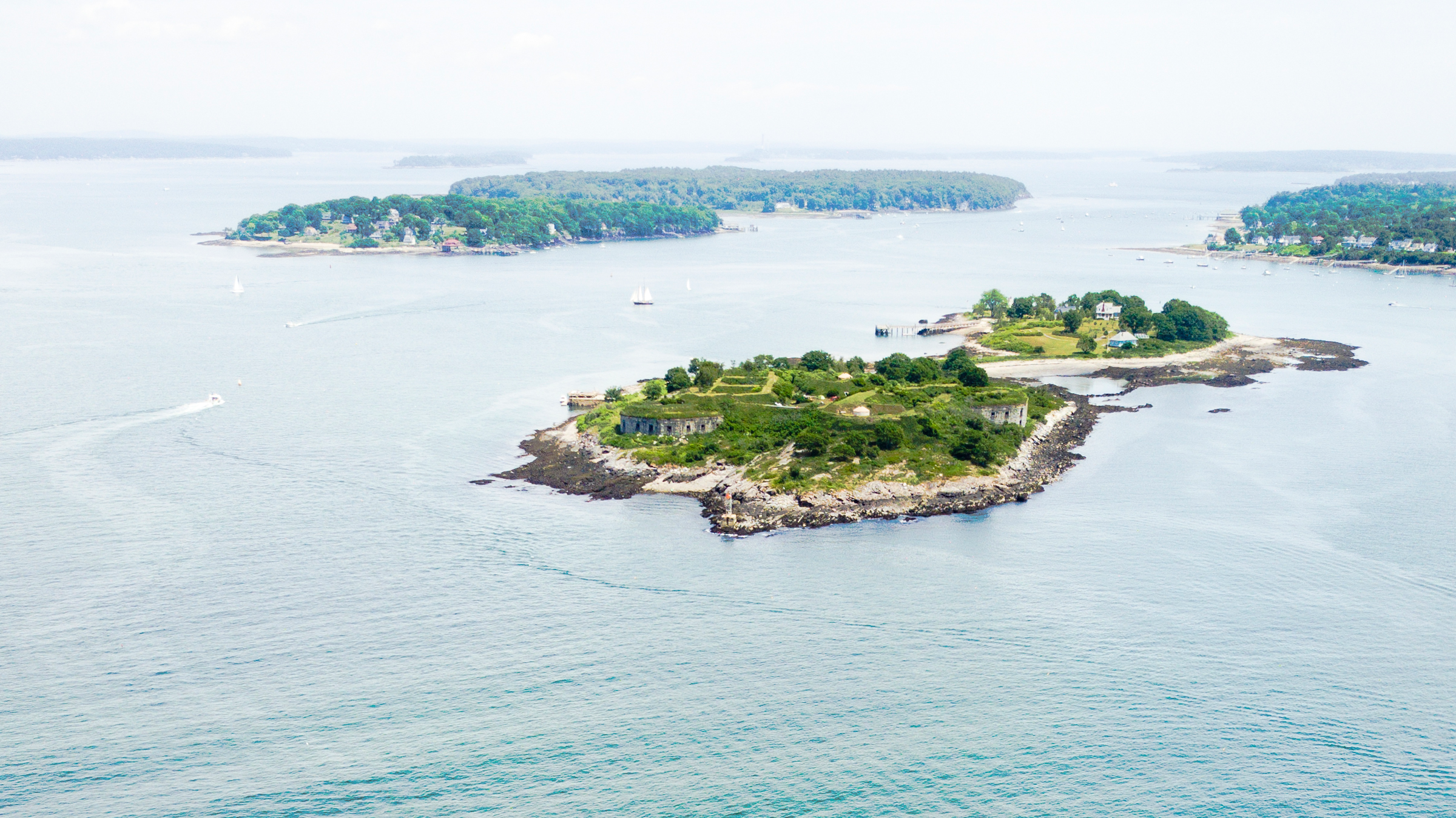 An aerial view of a small island featuring historic stone fortifications surrounded by water in Portland Maine.