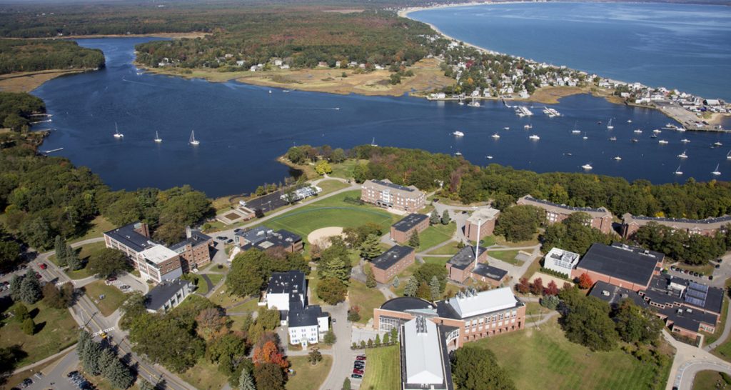 An aerial view of the University of New England's campus overlooking Casco Bay and the coastal town of Biddeford, Maine.