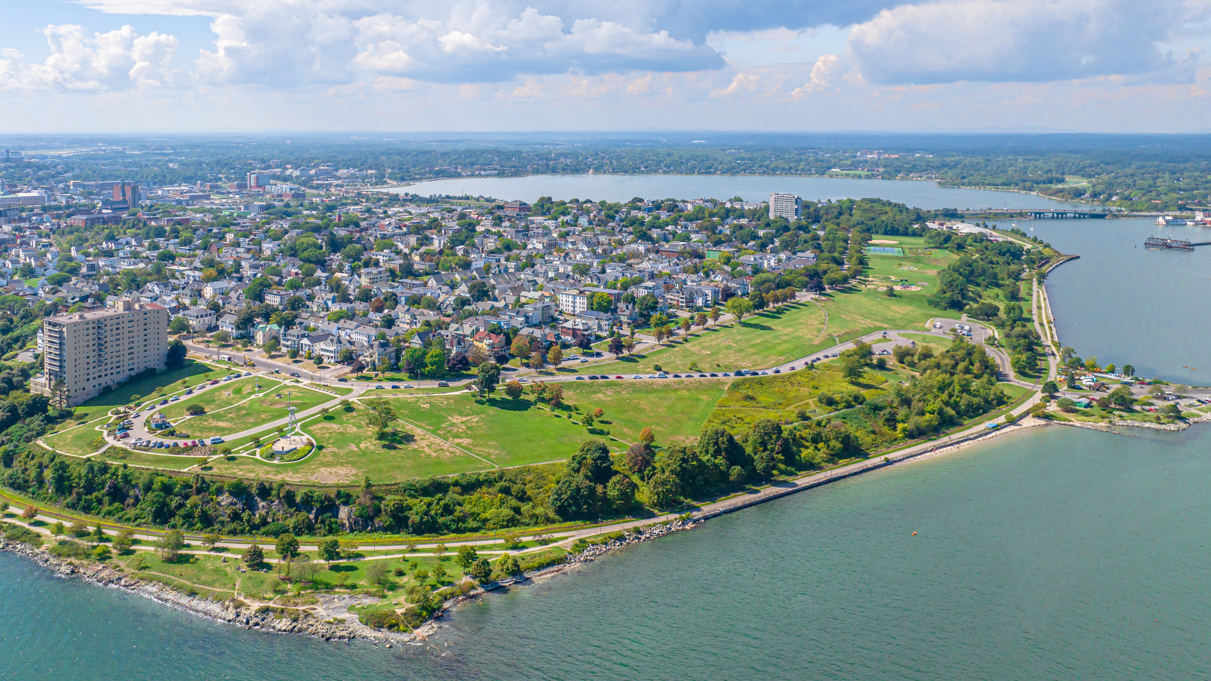 An aerial view of a coastal city with a large park and water in Portland Maine.