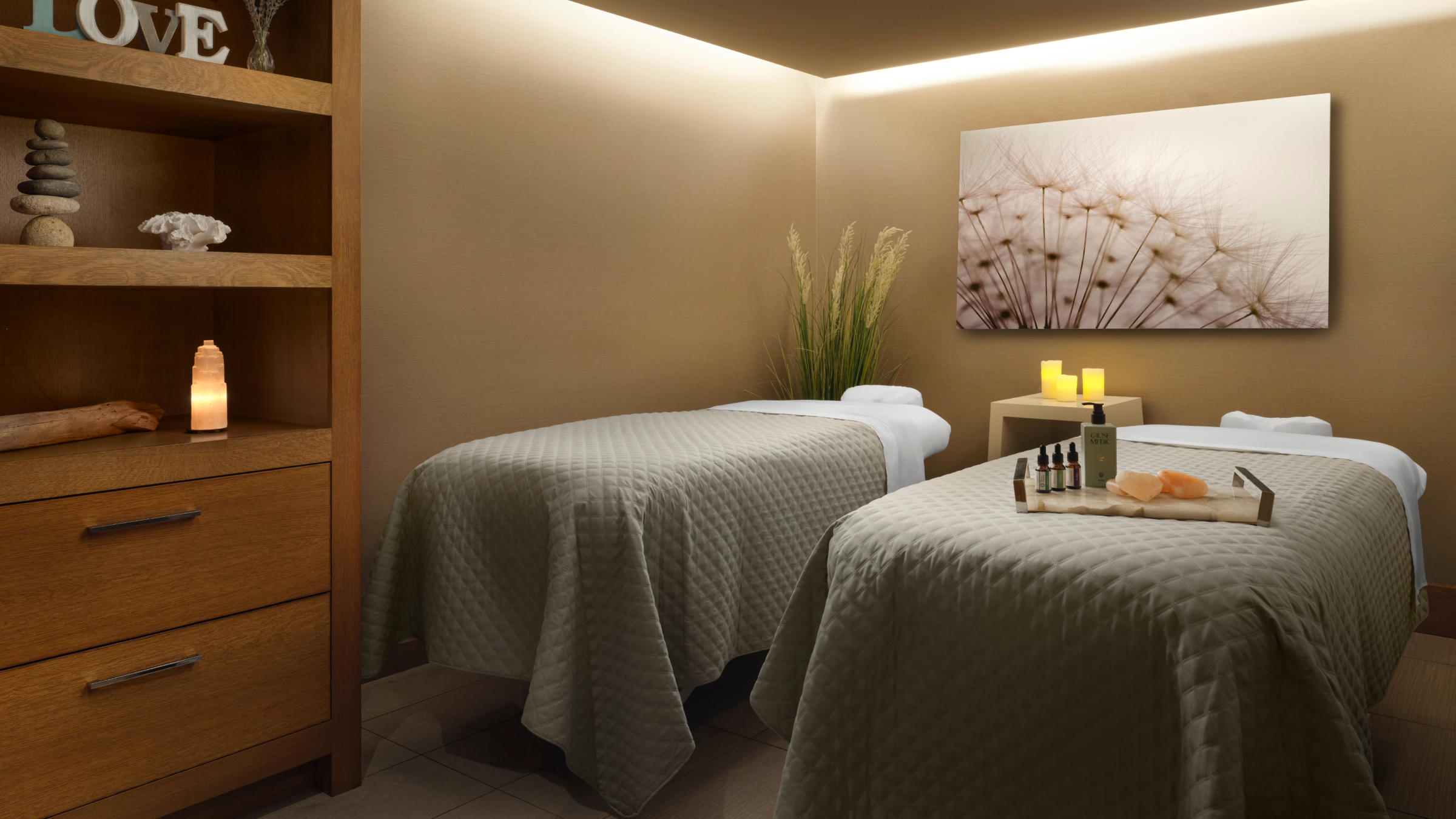A serene spa treatment room with two massage tables and calming decor in Portland Maine.