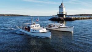 Boats cruising by lighthouse - Photo Courtesy of Casco Bay Custom Charters