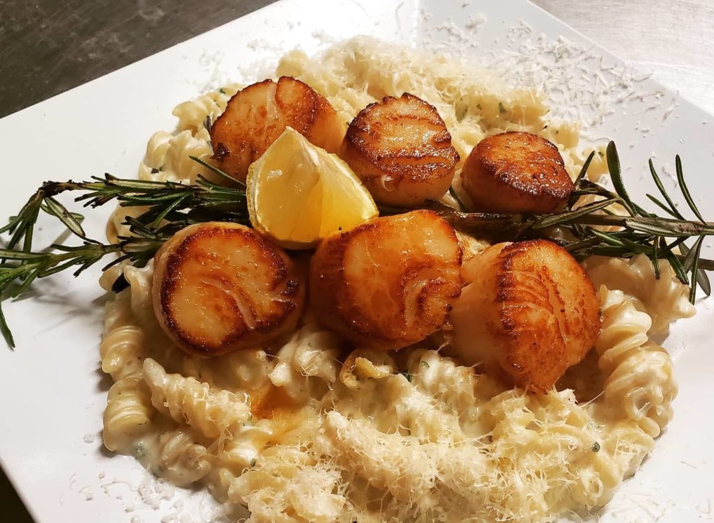 Plated Scallops and Asparagus on Pasta, Photo Courtesy of Photo Credit: Petrillos / Visit Freeport